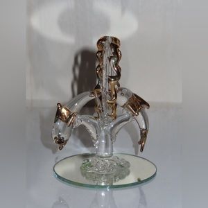 A pair of dolphins diving through a circle with a chrome/gold color lining